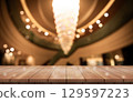 Empty wooden table top with lights bokeh on blur restaurant background. 129597223