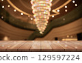 Empty wooden table top with lights bokeh on blur restaurant background. 129597224