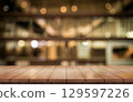 Empty wooden table top with lights bokeh on blur restaurant background. 129597226