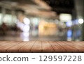 Empty wooden table top with lights bokeh on blur restaurant background. 129597228
