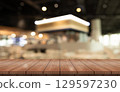 Empty wooden table top with lights bokeh on blur restaurant background. 129597230