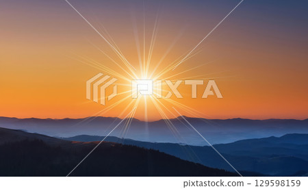 glowing sun rises above serene landscape, symbolizing hope and positive energy 129598159