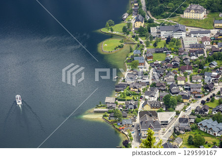 Hallstatt, Austria - June 17, 2023: View of the city of Hallstatt and Lake Hallstattersee from a mountain in Austria Hallstatt, Austria - June 17, 2023: View of the city of Hallstatt and Lake Hallstattersee from a mountain in Austria 129599167