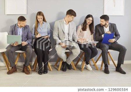 Young hr applicants sitting in queue preparing for important interview, vacancy candidates waiting  129600384