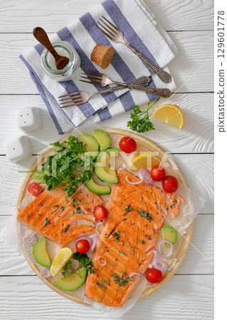 grilled salmon fillet on circle wooden board grilled salmon fillet on circle wooden board 129601778