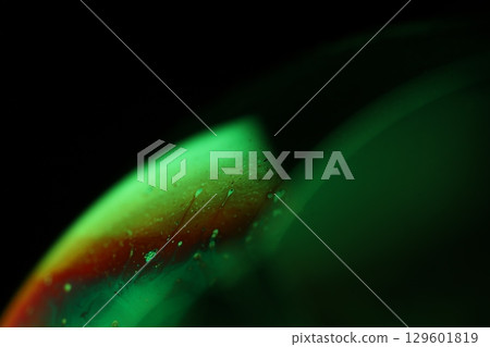 Green liquid film, fantastic bubbles connections, fluid movement, dark fantastic background, transparent oil, green ink 129601819