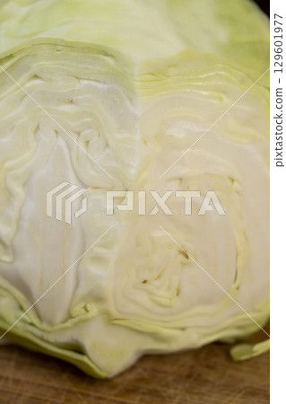 cut cabbage during slicing for salad preparation, pieces of sliced white cabbage , details of fresh cabbage chopped into small pieces for convenience of cooking 129601977