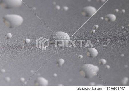 smooth silver colored metal surface covered with drops of pure water, wet silver-colored metal painted to protect aluminum alloy and metals, close up smooth silver colored metal surface covered with drops of pure water, wet silver-colored metal painted to protect aluminum alloy and metals, close up 129601981