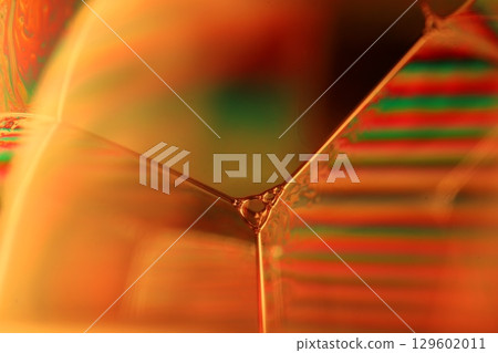 Orange coloured liquid surface, fluid effect, bright chemistry, geometric shapes 129602011