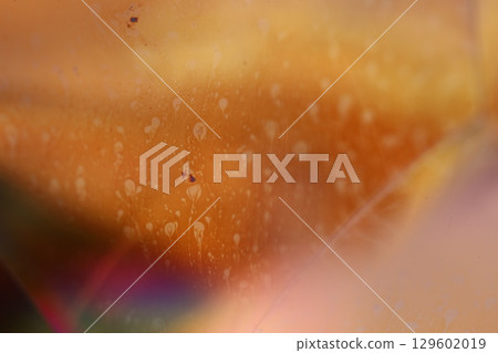 Orange coloured liquid surface, fluid effect, bright chemistry, geometric shapes 129602019