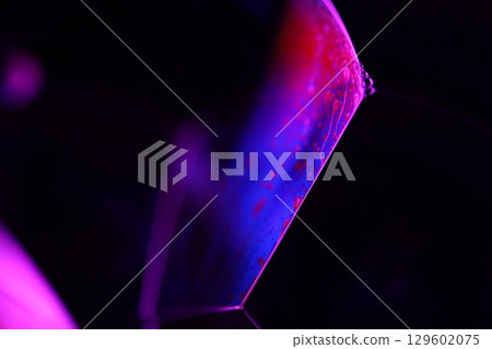 Purple liquid edge on black background 129602075