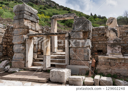 Ancient City of Ephesus ruins with headless statue and stone structures, Selcuk, Turkey 129602248