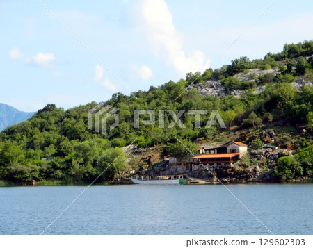 Charming Restaurant by the Tranquil Waters of Skadar Lake in Montenegro During a Sunny Afternoon 129602303