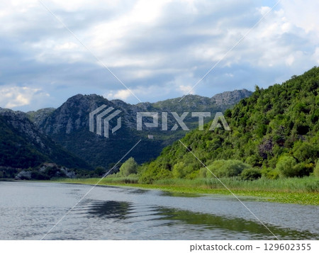 Serenity at Skadar Lake, Where Mountains Embrace Tranquil Waters in Montenegro Serenity at Skadar Lake, Where Mountains Embrace Tranquil Waters in Montenegro 129602355