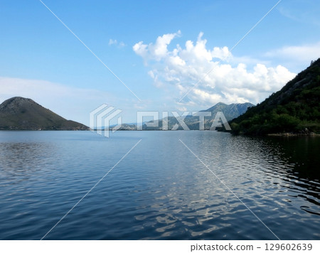 Breathtaking Afternoon Tranquility Over Skadar Lake in Montenegro With Majestic Mountains in View Breathtaking Afternoon Tranquility Over Skadar Lake in Montenegro With Majestic Mountains in View 129602639