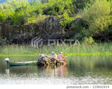 Fishing Serenity at Skadar Lake, Montenegro With Lush Landscapes and Calm Waters 129602654