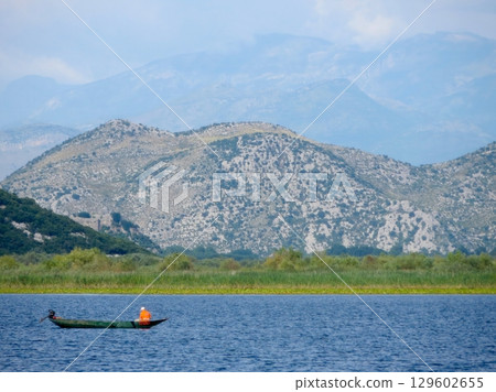Fishing on the Tranquil Waters of Skadar Lake in Montenegro Surrounded by Stunning Landscapes Fishing on the Tranquil Waters of Skadar Lake in Montenegro Surrounded by Stunning Landscapes 129602655