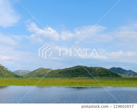 Discovering the Serene Beauty of Skadar Lake in Montenegro Under a Clear Blue Sky Discovering the Serene Beauty of Skadar Lake in Montenegro Under a Clear Blue Sky 129602657