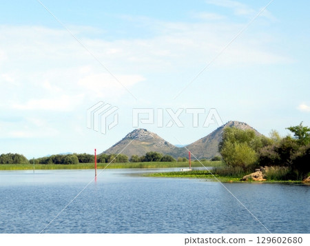 Scenic View of Skadar Lake in Montenegro Showcasing Peaceful Waters and Rolling Hills Scenic View of Skadar Lake in Montenegro Showcasing Peaceful Waters and Rolling Hills 129602680