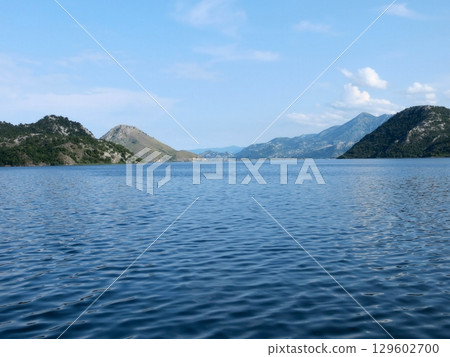 Explore the Serene Beauty of Skadar Lake in Montenegro With Majestic Mountains Surrounding Explore the Serene Beauty of Skadar Lake in Montenegro With Majestic Mountains Surrounding 129602700