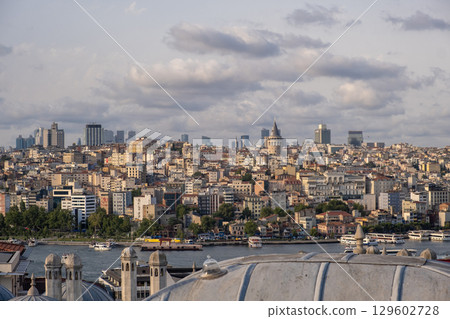 A panoramic view captures the bustling skyline of Istanbul along the Bosphorus, blending modern buildings with historic structures. A panoramic view captures the bustling skyline of Istanbul along the Bosphorus, blending modern buildings with historic structures. 129602728