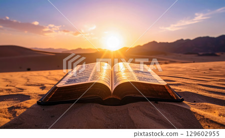 Open book and morning sun in the desert / A spiritual landscape symbolizing tranquility and hope 129602955
