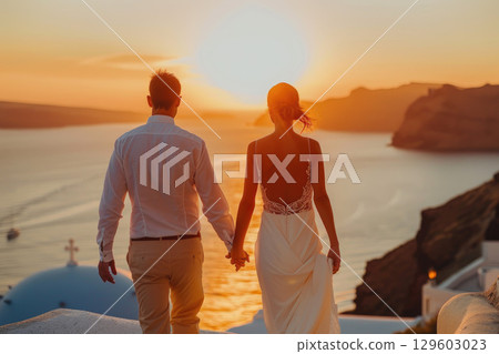 Romantic Sunset Wedding Couple Holding Hands on Beach 129603023