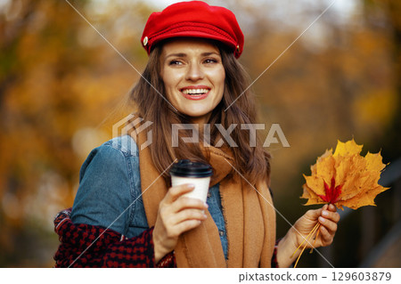 happy stylish female in jeans shirt and red hat happy stylish female in jeans shirt and red hat 129603879