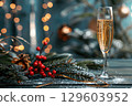Festive Champagne Glass with Holiday Decor and Bokeh Lights in Background 129603952