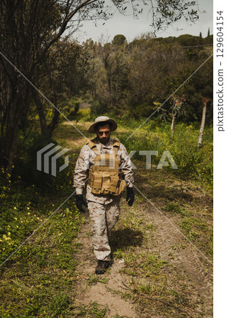 Soldier Walking Back To The Base In The Nature Soldier Walking Back To The Base In The Nature 129604154