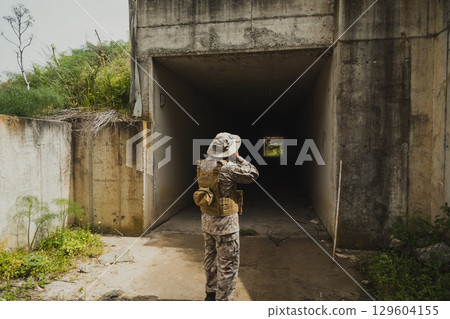 War Journalist In Uniform Taking Photos At An Old Building War Journalist In Uniform Taking Photos At An Old Building 129604155