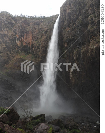 A white torrent splitting the black rocks - the dance of Wallaman Falls 129604180