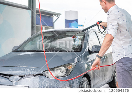 Car wash background. Car washing station foam. Man self service detail splash. Car wash background. Car washing station foam. Man self service detail splash. 129604376