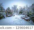 Old country cottage courtyard with a large bench, swing. Large bench swing in garden in winter 129604617