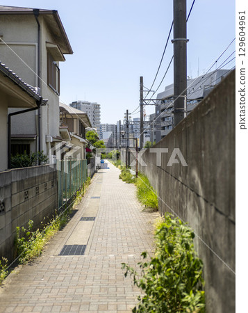 Scenery of an alleyway next to an elevated railway line Scenery of an alleyway next to an elevated railway line 129604961