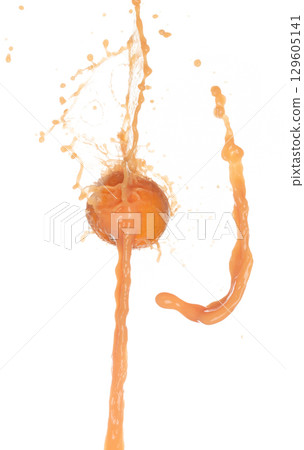 Orange Juice pouring down in Shape form line. Orange juicy hit full fruit fluttering explosion in air, liquid water splash spill like explosion droplet. White background isolated, stop motion freeze 129605141