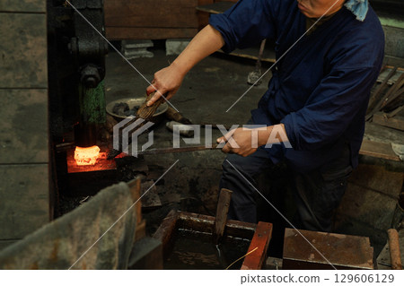 Filming a blacksmith forging a Japanese sword using a unique Japanese forging method Filming a blacksmith forging a Japanese sword using a unique Japanese forging method 129606129