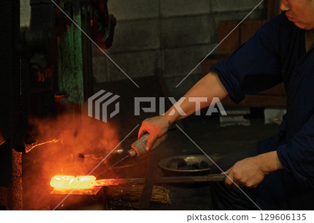 Filming a blacksmith forging a Japanese sword using a unique Japanese forging method Filming a blacksmith forging a Japanese sword using a unique Japanese forging method 129606135