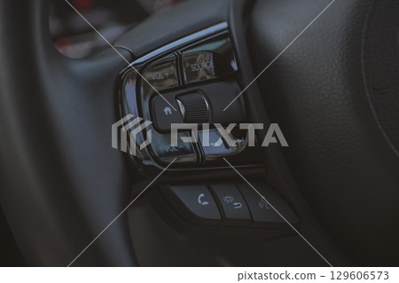 interior view of car with black leather, close up steering wheel with button interior view of car with black leather, close up steering wheel with button 129606573