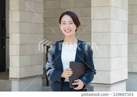Businesswoman with file Businesswoman with file 129607101