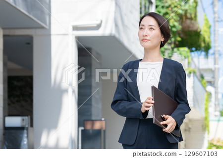Businesswoman with file Businesswoman with file 129607103