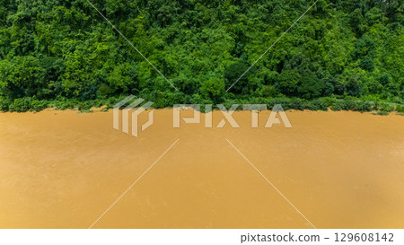 Aerial view of lush green forest with Kok river flowing in Chiang Rai province of Thailand. 129608142