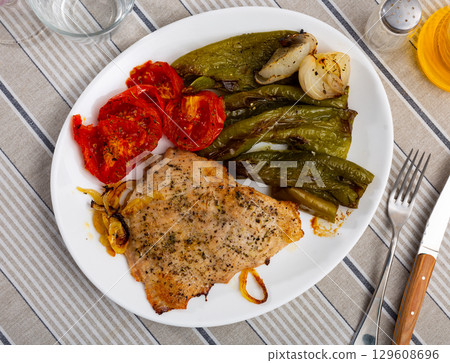 Lunch served on plate - pork chop with stewed vegetable tomato and bell pepper Lunch served on plate - pork chop with stewed vegetable tomato and bell pepper 129608696