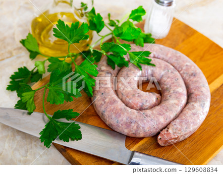 There is ring of homemade raw sausage made from meat mix There is ring of homemade raw sausage made from meat mix 129608834