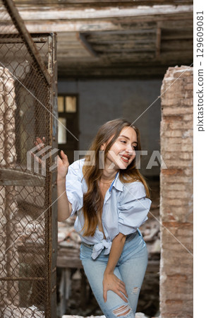 Desirable young woman posing in deserted building 129609081