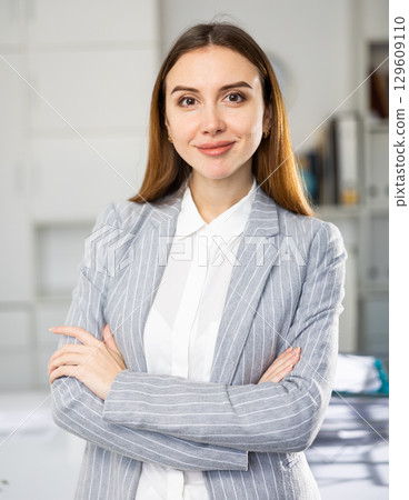 Portrait of positive smiling businesswoman in suit 129609110