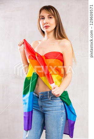 Young woman wrapped in LGBT flag 129609571