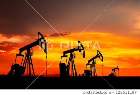 Panorama of an oil field with multiple pump jacks Panorama of an oil field with multiple pump jacks 129611197