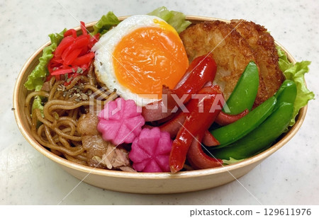 A traditional Korean dosirak, beautifully arranged with rice, assorted banchan, and savory proteins. Balanced and visually inviting, its a portable meal packed with vibrant flavors. 129611976