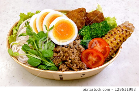 A traditional Korean dosirak, beautifully arranged with rice, assorted banchan, and savory proteins. Balanced and visually inviting, its a portable meal packed with vibrant flavors. 129611998